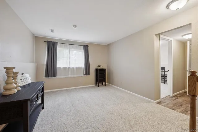 a front view of house with yard and trees in the background