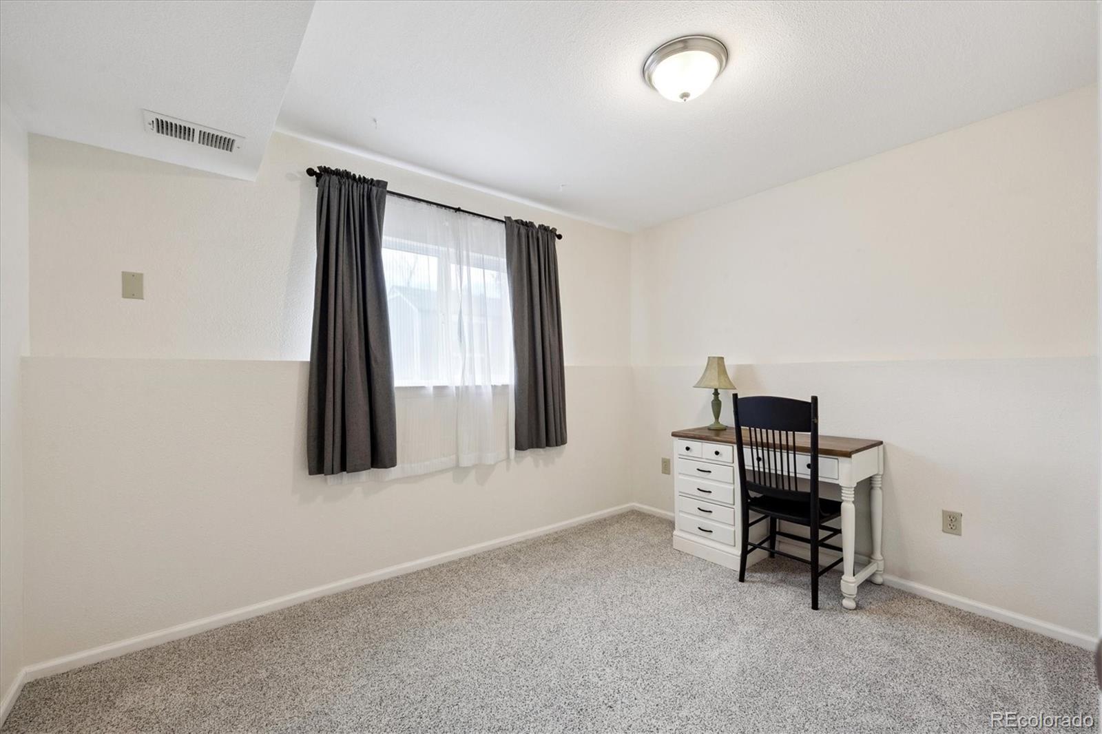 704 Madison Way Bennett, CO 80102 - Photo 19 of 29 a view of workspace with furniture and a window