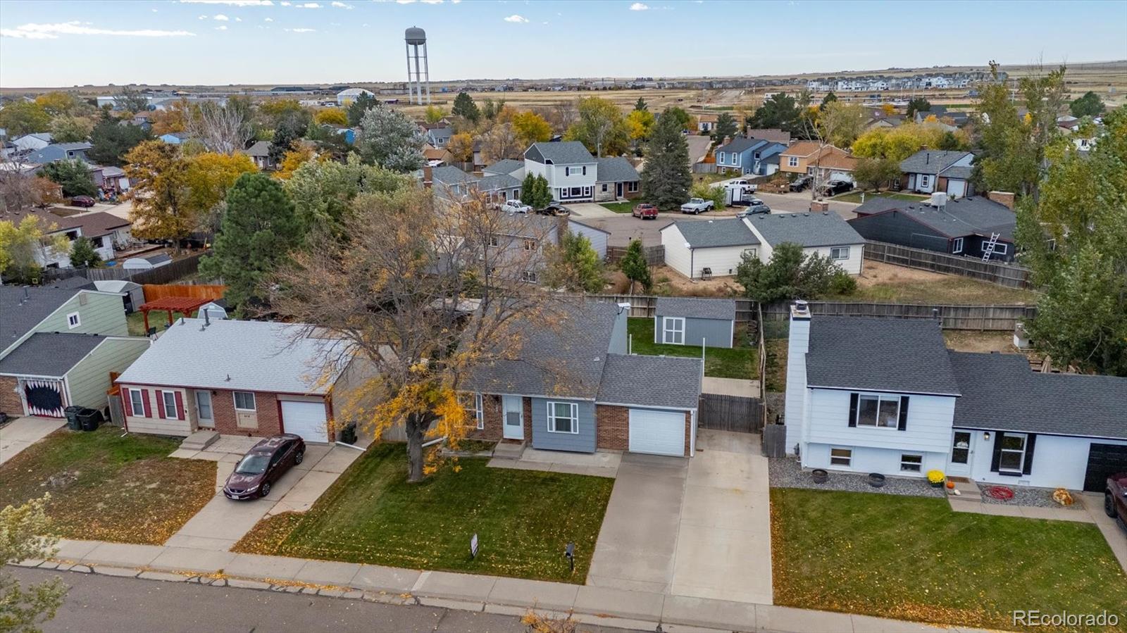 704 Madison Way Bennett, CO 80102 - Photo 25 of 29 an aerial view of multiple houses with a yard