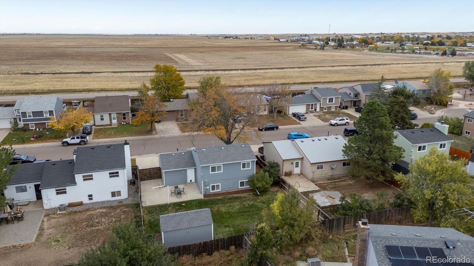 704 Madison Way Bennett, CO 80102 - Photo 28 of 29 an aerial view of a building with outdoor space and seating