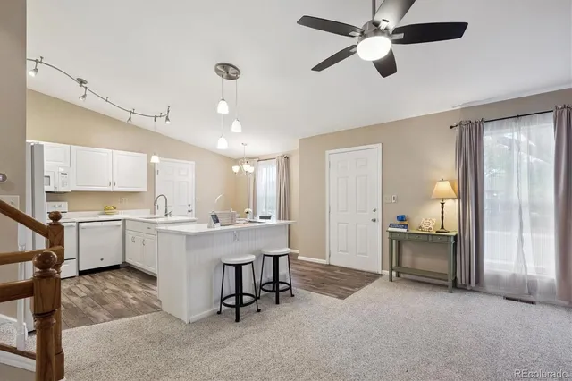 a view of kitchen with furniture and a ceiling fan
