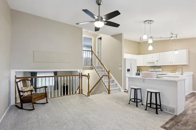 a kitchen with white cabinets and white appliances