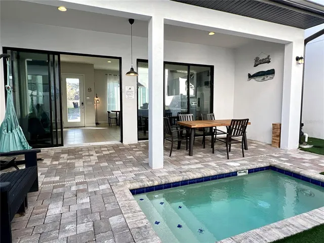 a view of swimming pool with outdoor seating