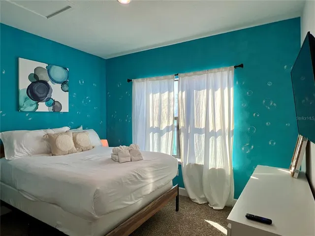 a bedroom with a bed and window