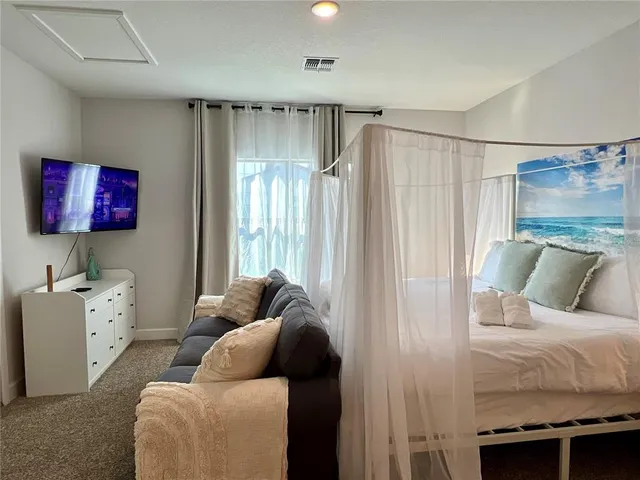 a bedroom with a bed and a window