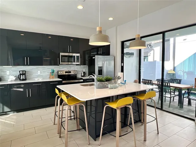 a kitchen with stainless steel appliances kitchen island granite countertop a sink and cabinets