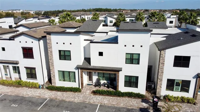 a view of a white building with large windows