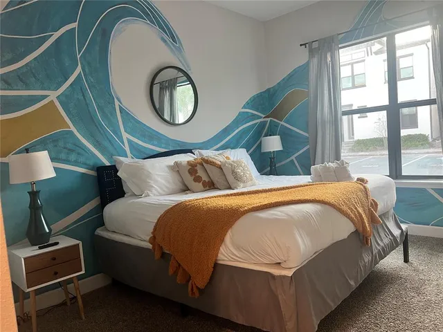 a bedroom with a bed and a window