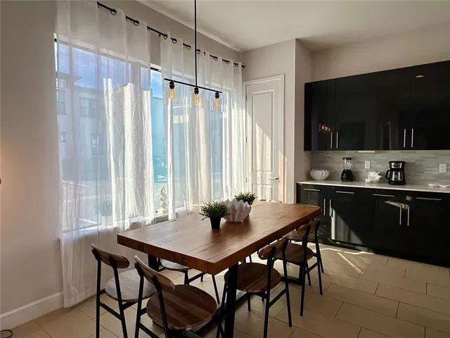 a view of a dining table and chairs in a kitchen