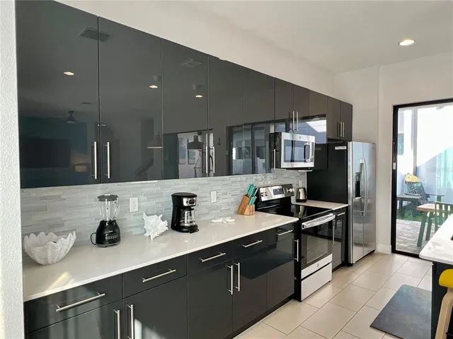 a kitchen with stainless steel appliances a sink stove and refrigerator