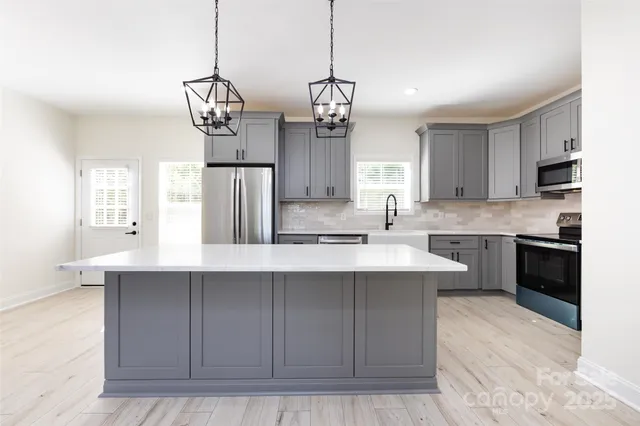 a kitchen with cabinets a sink and stainless steel appliances