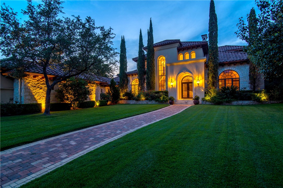 a view of a big building with a big yard and large trees