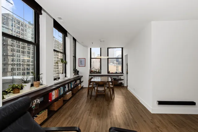 a very nice looking room with wooden floor and furniture