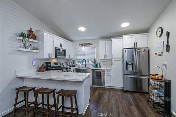 a kitchen with refrigerator cabinets and wooden floor