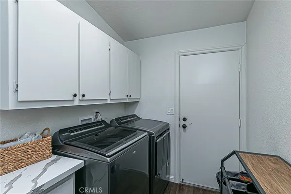 a kitchen with a stove and a white cabinet