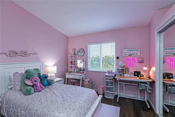 a bedroom with a bed and a desk