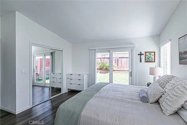 a bedroom with a bed and large windows