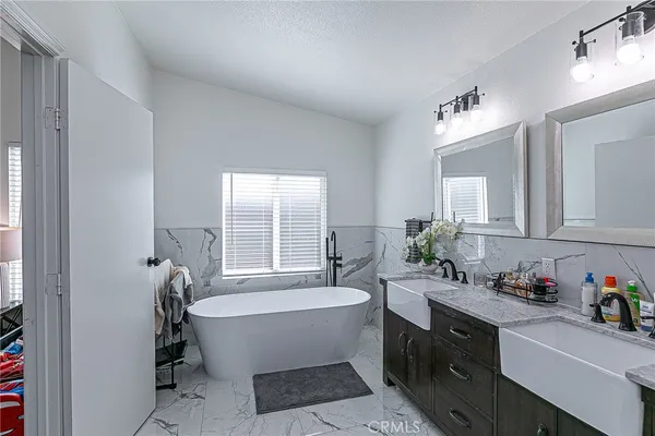 a bathroom with a bathtub a sink and a window