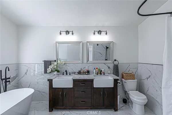a bathroom with a double vanity sink and a mirror