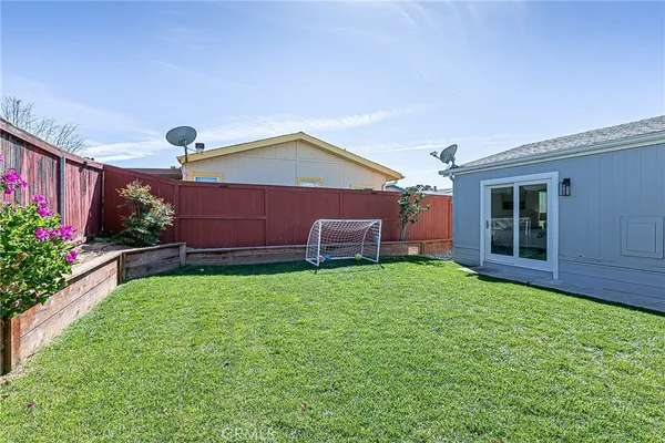 a backyard of a house with lots of green space and plants