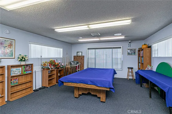 a living room with furniture gym equipment and window