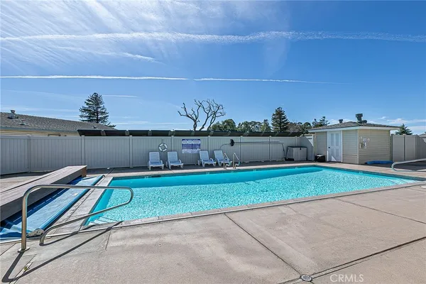 a view of backyard with seating area and trees