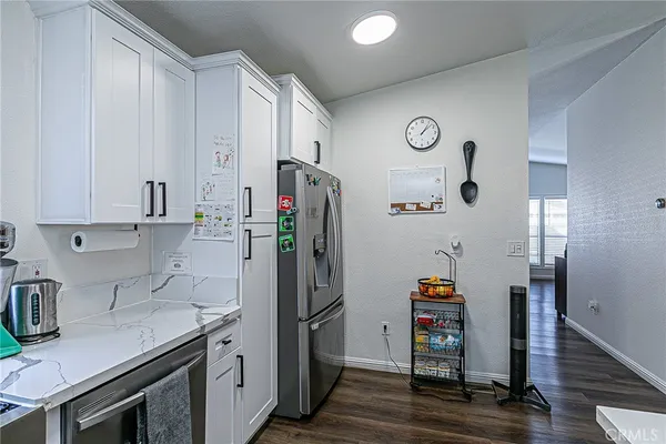 a kitchen with stainless steel appliances a refrigerator and a stove top oven