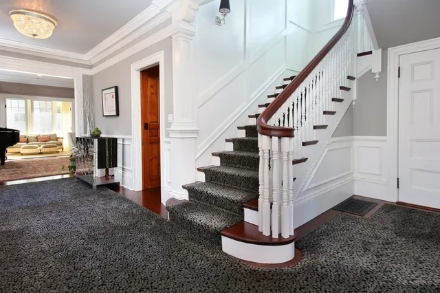 a view of entryway and hall with wooden floor