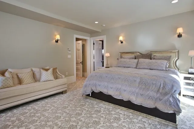 a spacious bedroom with a bed and a couch