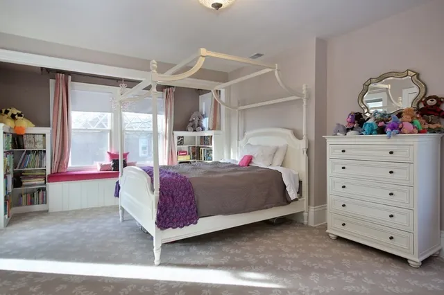 a bedroom with a bed and a mirror