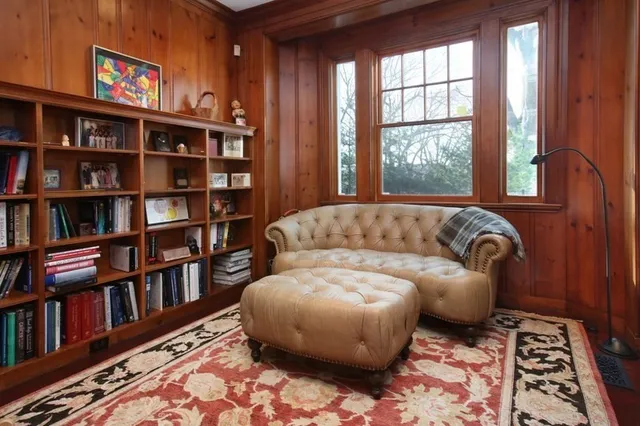 a living room with a couch and a book shelf