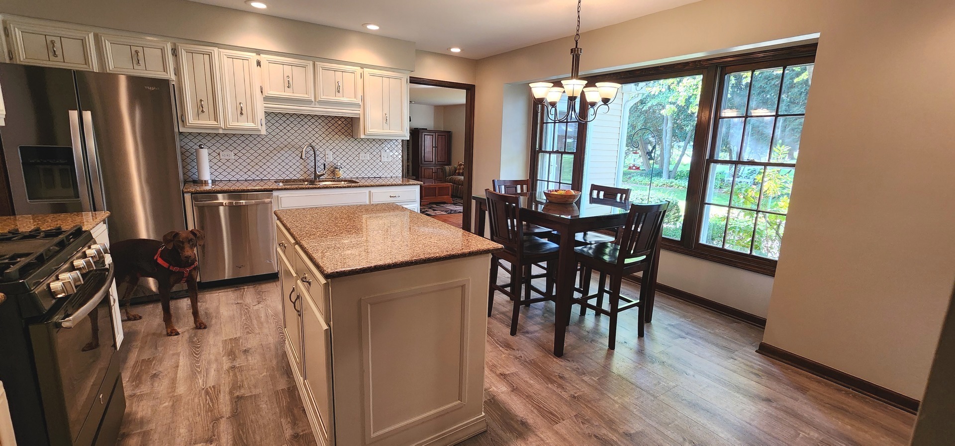 68 Winthrop New Road Sugar Grove, IL 60554 - Photo 7 of 7 a kitchen with stainless steel appliances granite countertop a stove top oven a sink and a refrigerator with wooden floor