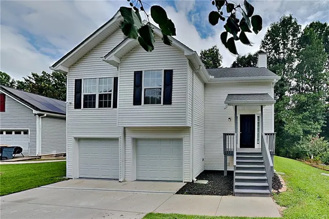 a front view of a house with garden