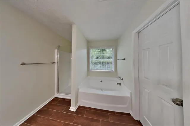 a bathroom with a bathtub and shower