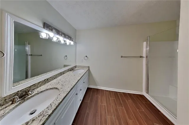 a bathroom with a double vanity sink and a mirror