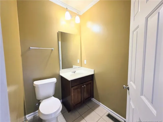 a bathroom with a toilet sink vanity and mirror