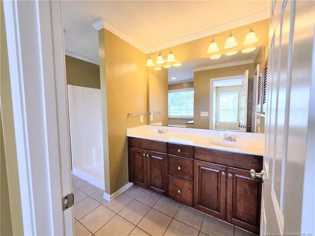 a spacious bathroom with a double vanity sink and a mirror