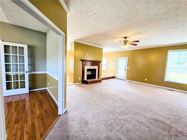 a view of empty room with a fireplace