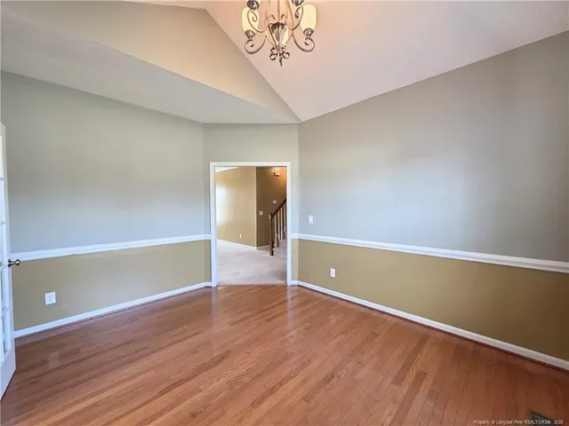 a view of room with window and wooden floor