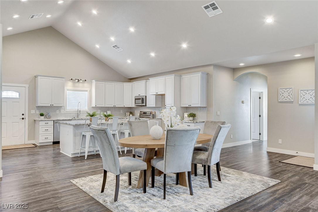 3196 Mateuse Street Logandale, NV 89021 - Photo 12 of 85 Dining area with high vaulted ceiling, arched walk