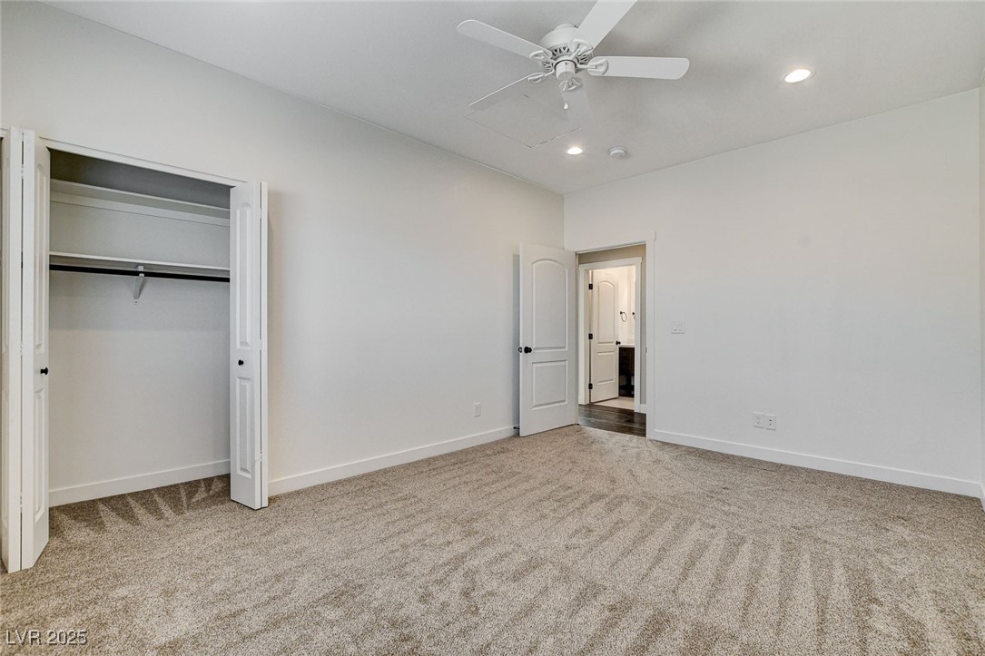 3196 Mateuse Street Logandale, NV 89021 - Photo 23 of 85 Bedroom 2 featuring carpet, ceiling fan, baseboard