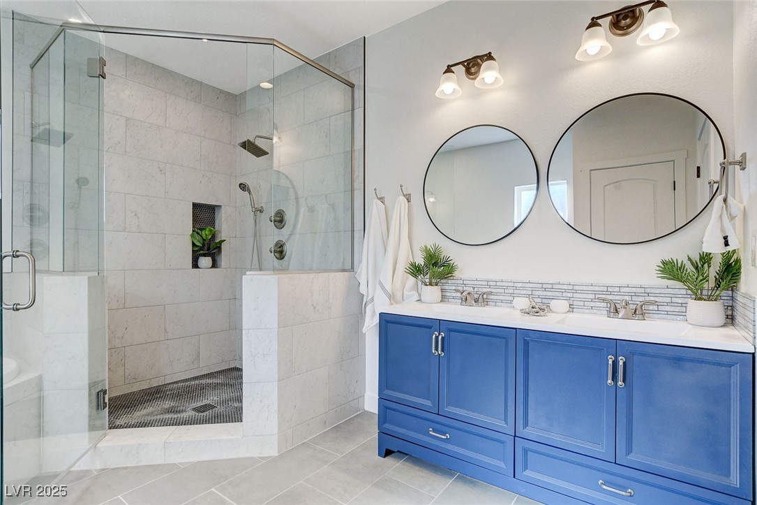 3196 Mateuse Street Logandale, NV 89021 - Photo 48 of 85 Bathroom with double vanity, a stall shower, a sin