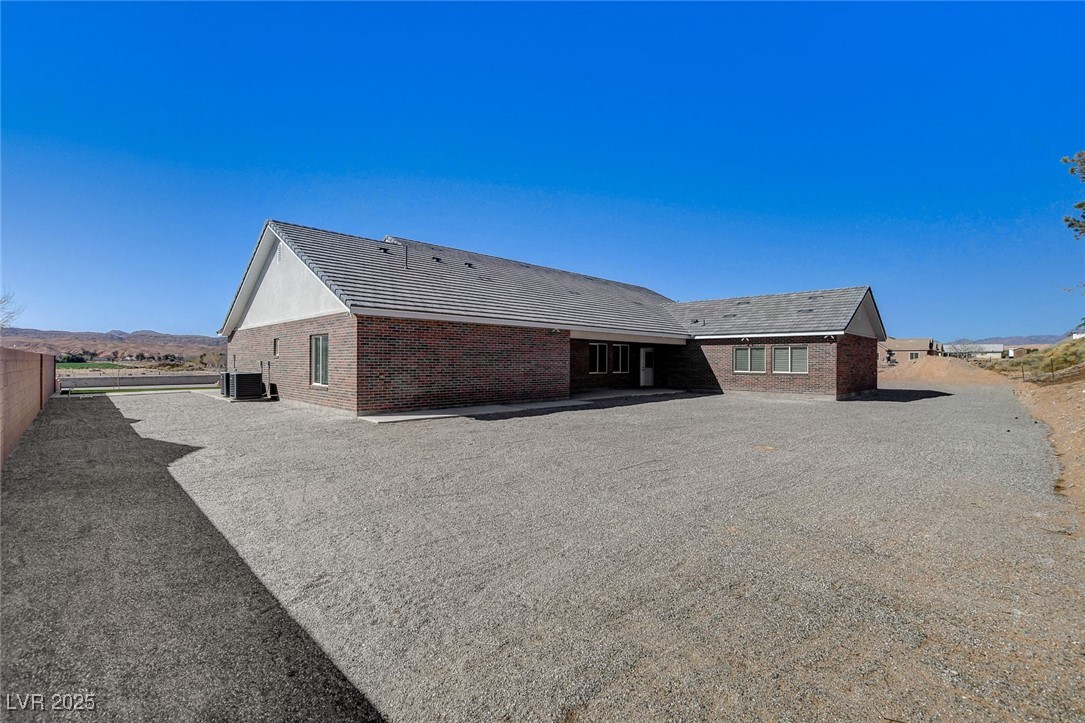 3196 Mateuse Street Logandale, NV 89021 - Photo 58 of 85 Rear view of property featuring brick siding, dual