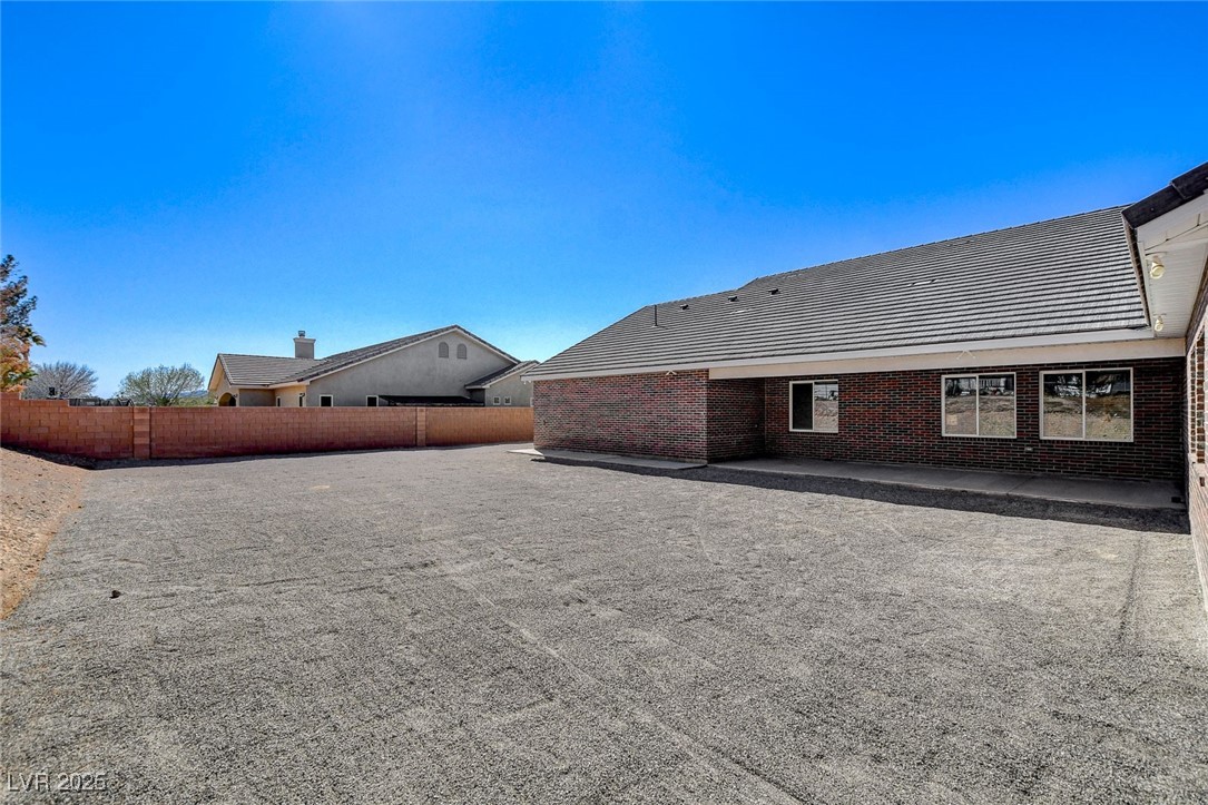 3196 Mateuse Street Logandale, NV 89021 - Photo 59 of 85 Back of property with fence, a patio, and brick si
