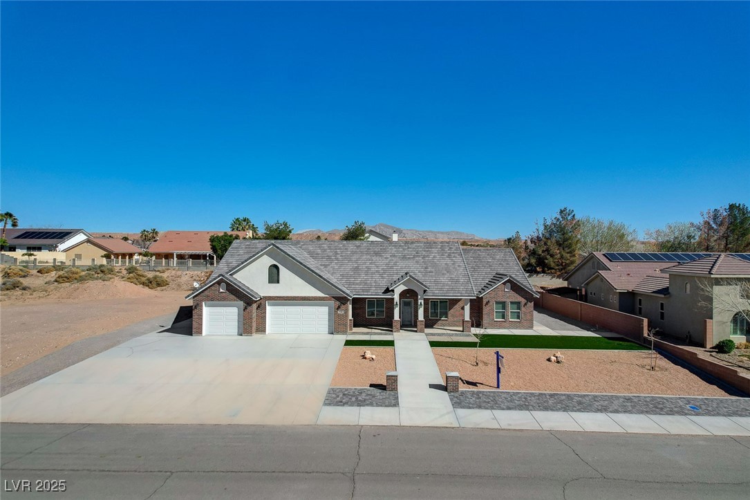 3196 Mateuse Street Logandale, NV 89021 - Photo 75 of 85 View of front facade featuring concrete driveway,