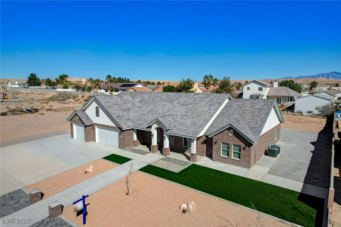 3196 Mateuse Street Logandale, NV 89021 - Photo 76 of 85 View of front of home featuring brick siding, driv