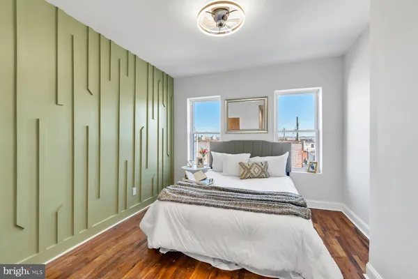 a bedroom with a large bed and a chandelier