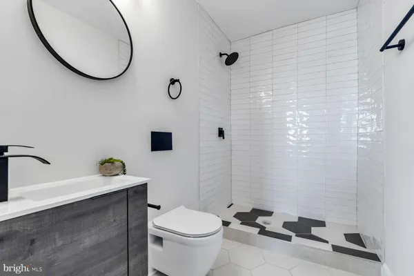 a bathroom with a sink mirror and toilet