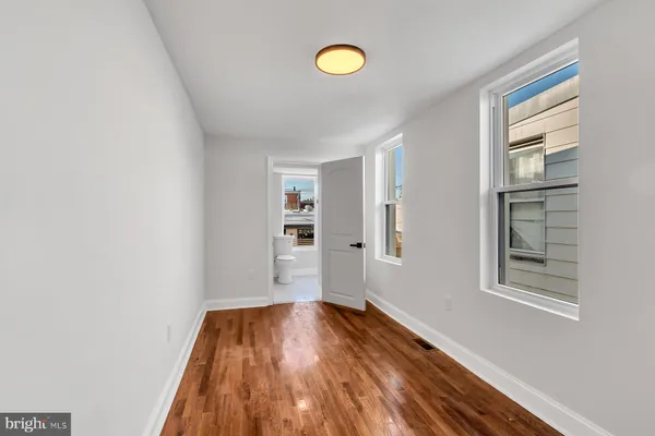 a view of a room with wooden floor and window