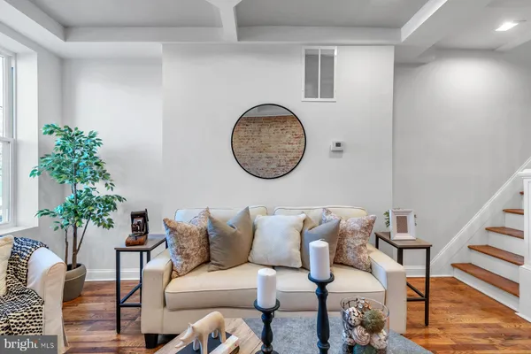 a living room with furniture and a potted plant